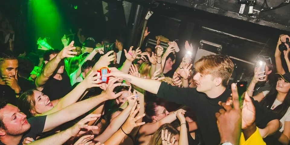 Declan meeting his community in a lively crowd