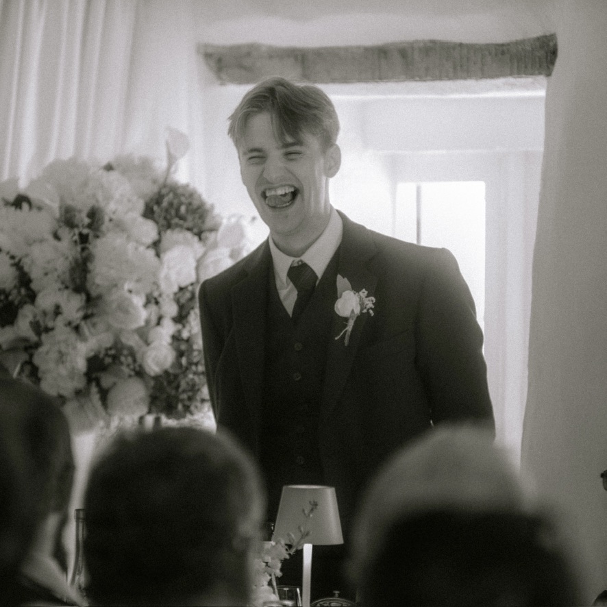 Declan Shinnick laughing at a wedding
